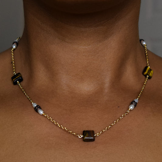 Handcrafted necklace with tiger's eye, metal, and pearl beads for elegant, refined style by Ayiti Chérie. Haitian-inspired, lifestyle brand