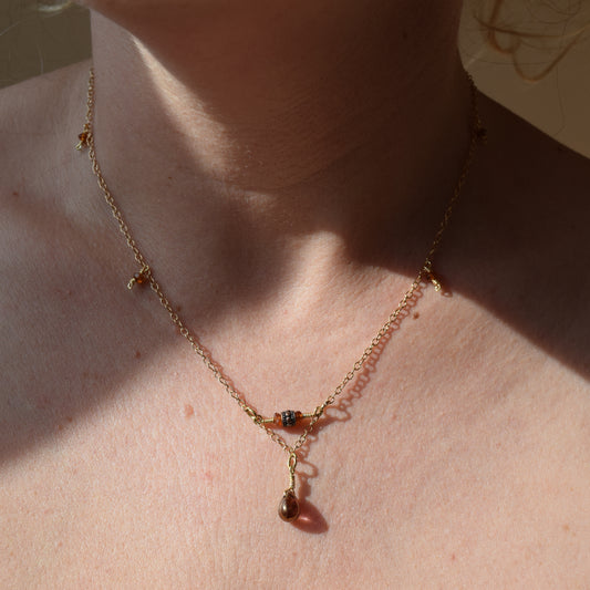 Handcrafted- Delicate curb chain, carnelian, carved drum and teardrop glass beads for elegant, refined style by Ayiti Chérie. Haitian-inspired, lifestyle brand