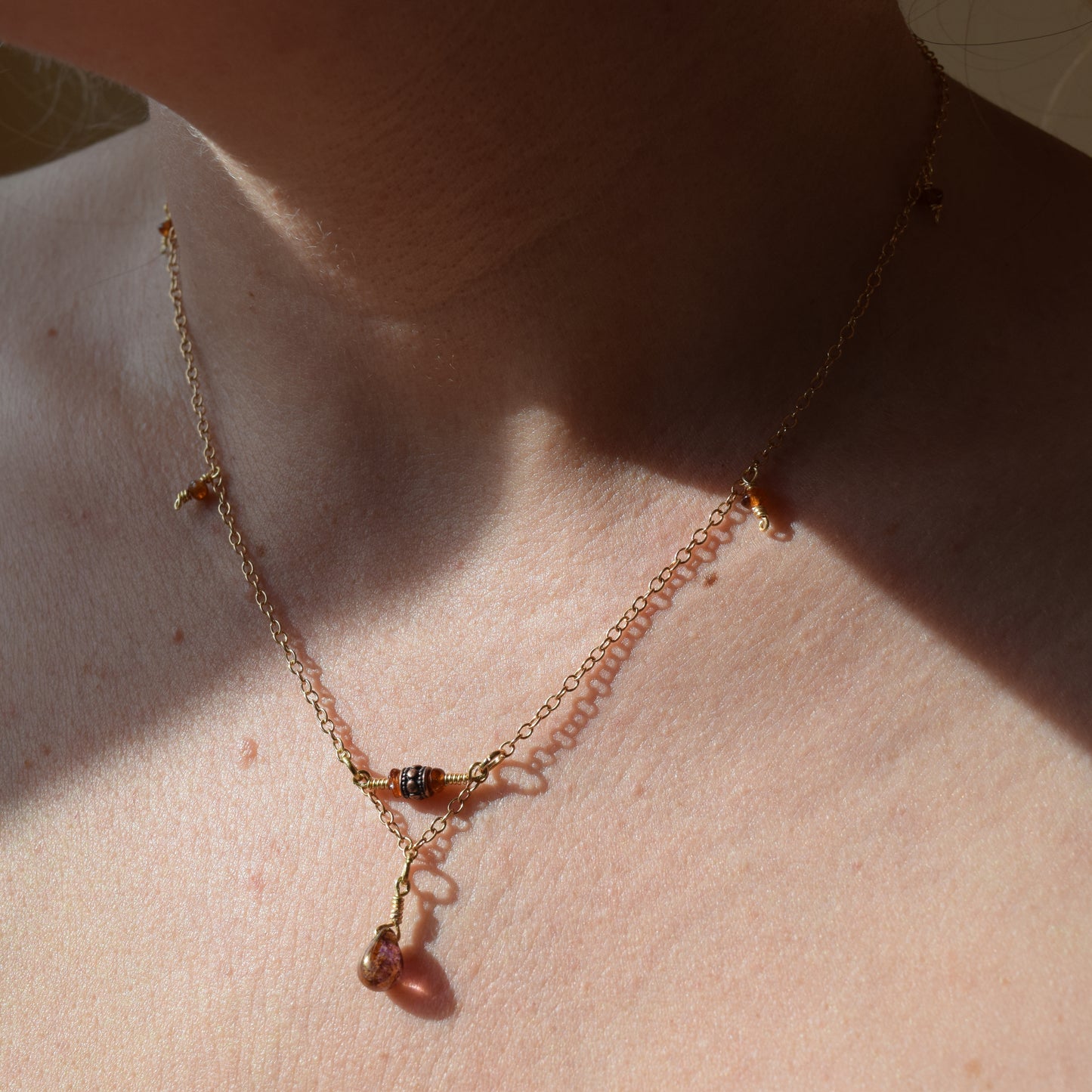 Handcrafted- Delicate curb chain, carnelian, carved drum and teardrop glass beads for elegant, refined style by Ayiti Chérie. Haitian-inspired, lifestyle brand