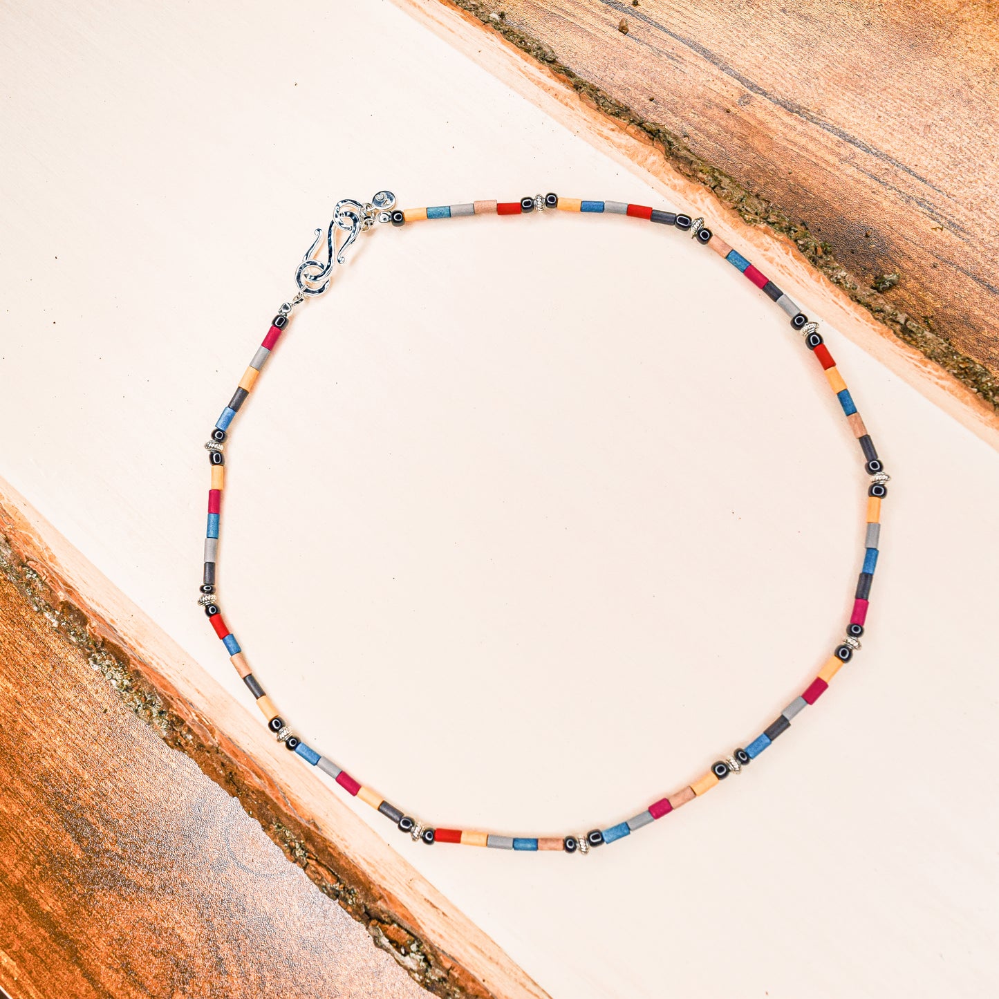 Handcrafted necklace- Painted wooden & carved metal beads for refined, modern elegance. Haitian-inspired, lifestyle brand