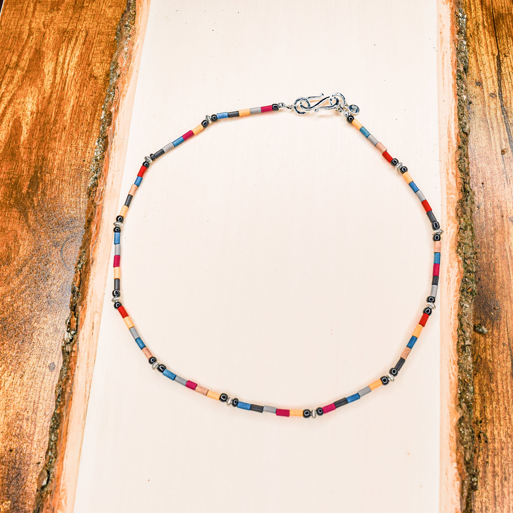 Handcrafted necklace- Painted wooden & carved metal beads for refined, modern elegance. Haitian-inspired, lifestyle brand