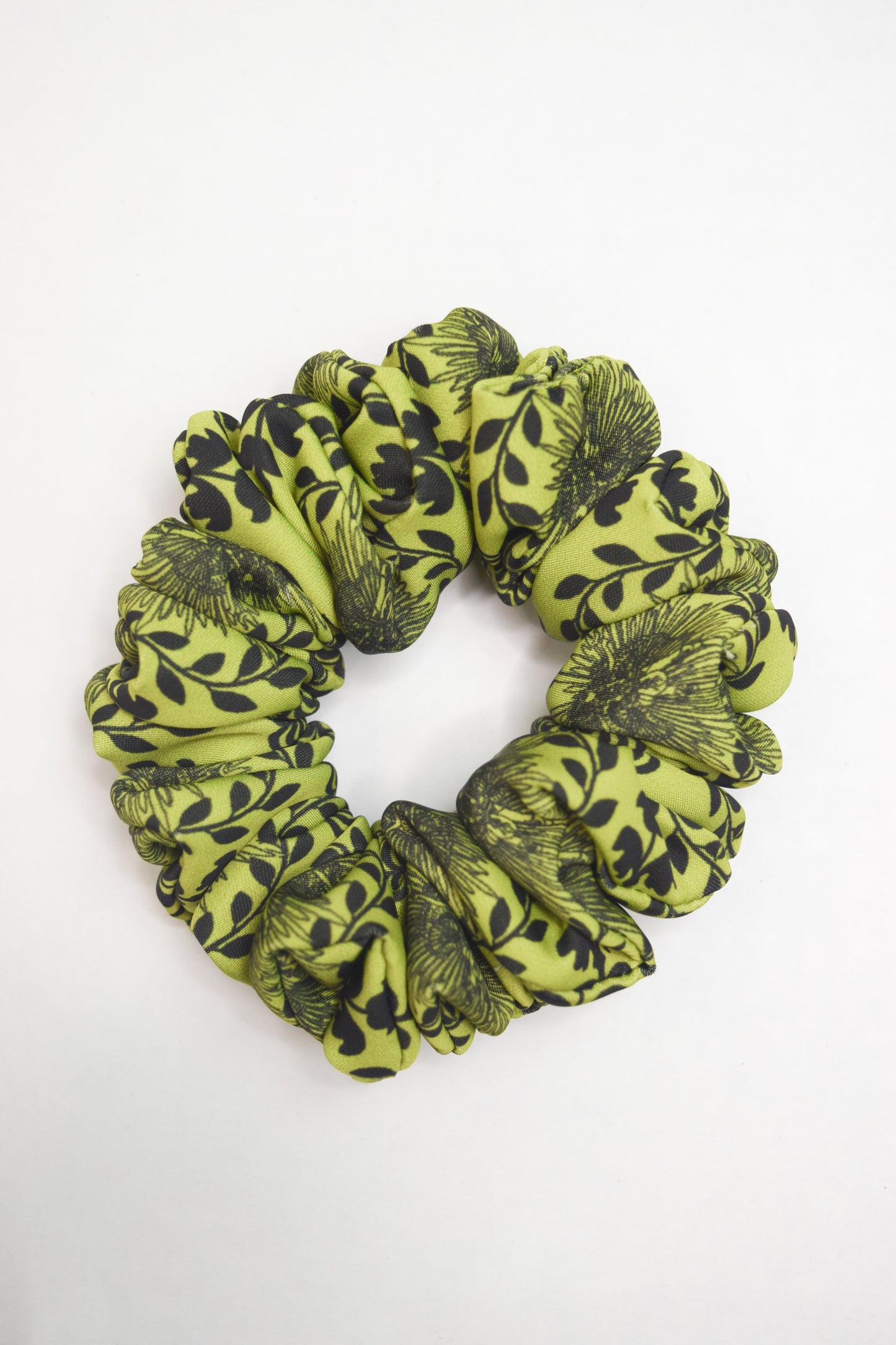 Scrunchie with a bright chartreuse green color and a carnival lady print by Ayiti Cherie