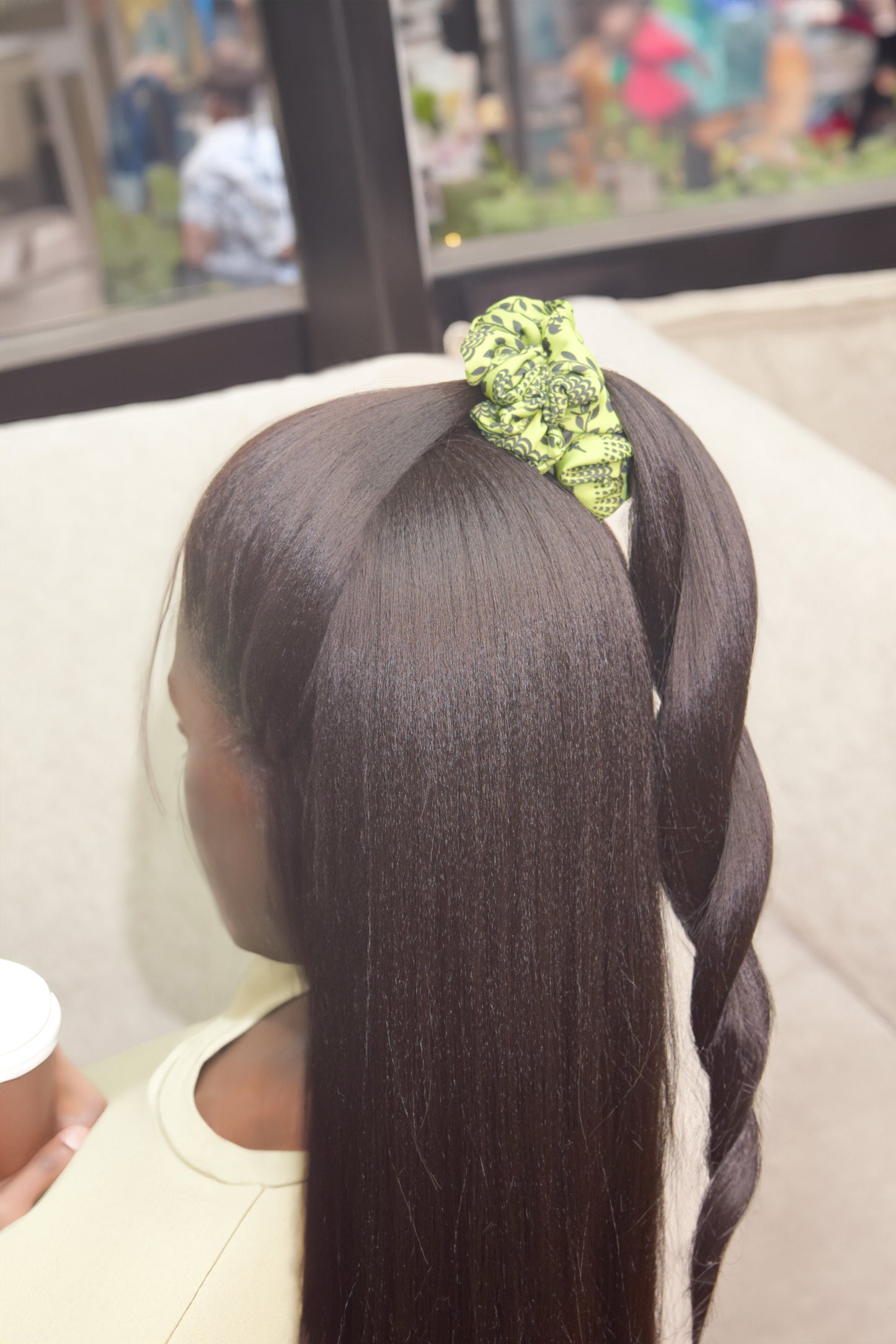 Scrunchie with a bright chartreuse green color and a carnival lady print by Ayiti Cherie