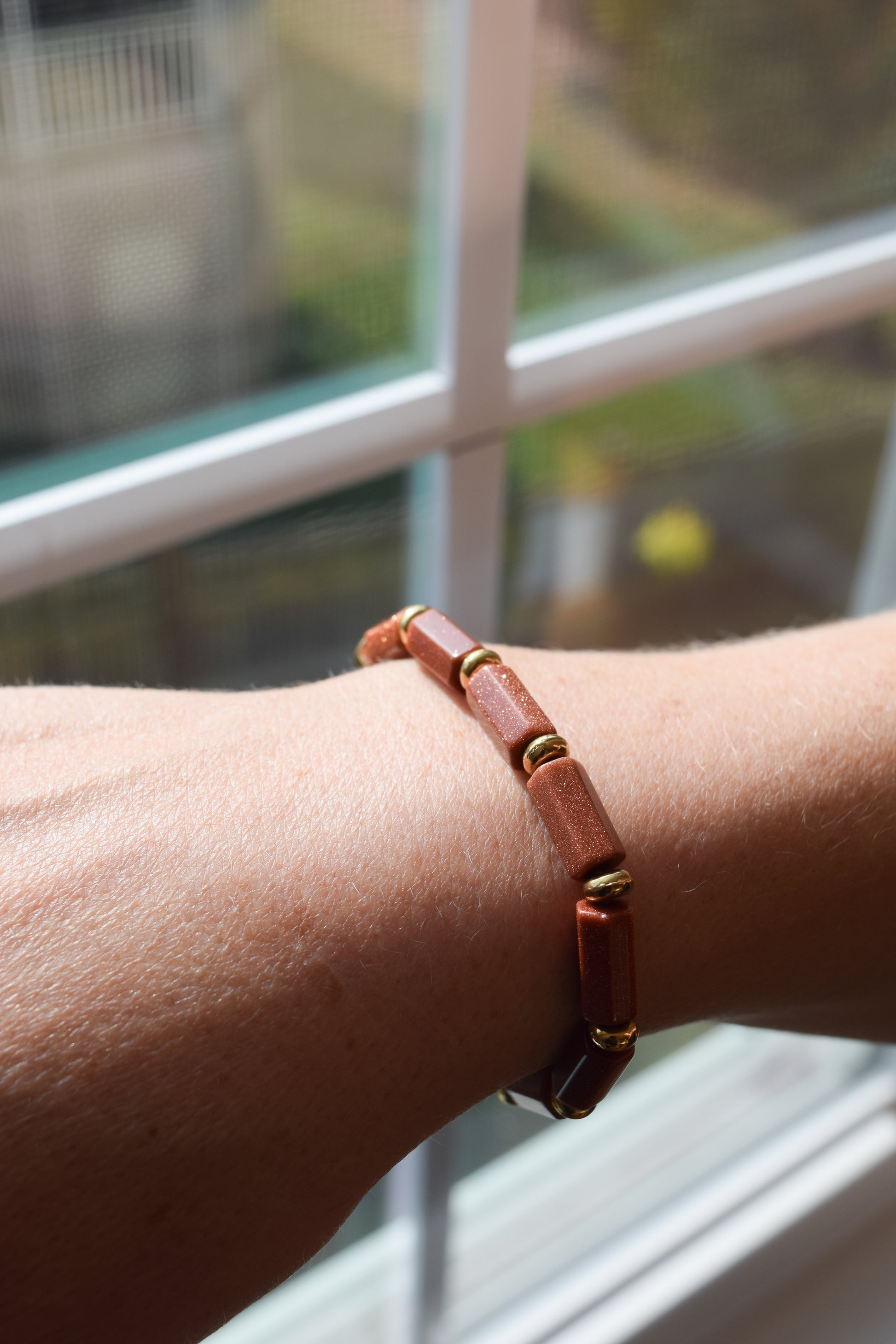 Handcrafted with goldstone & metal beads for elegant, refined style by Ayiti Chérie. Haitian-inspired, lifestyle brand