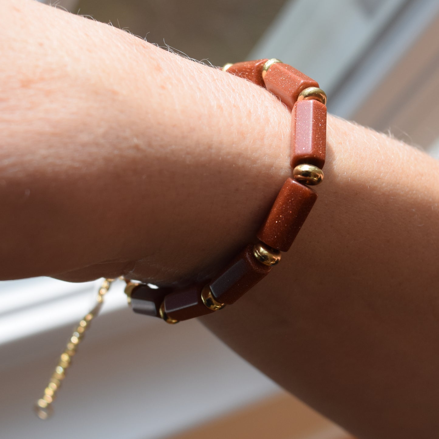 Handcrafted with goldstone & metal beads for elegant, refined style by Ayiti Chérie. Haitian-inspired, lifestyle brand