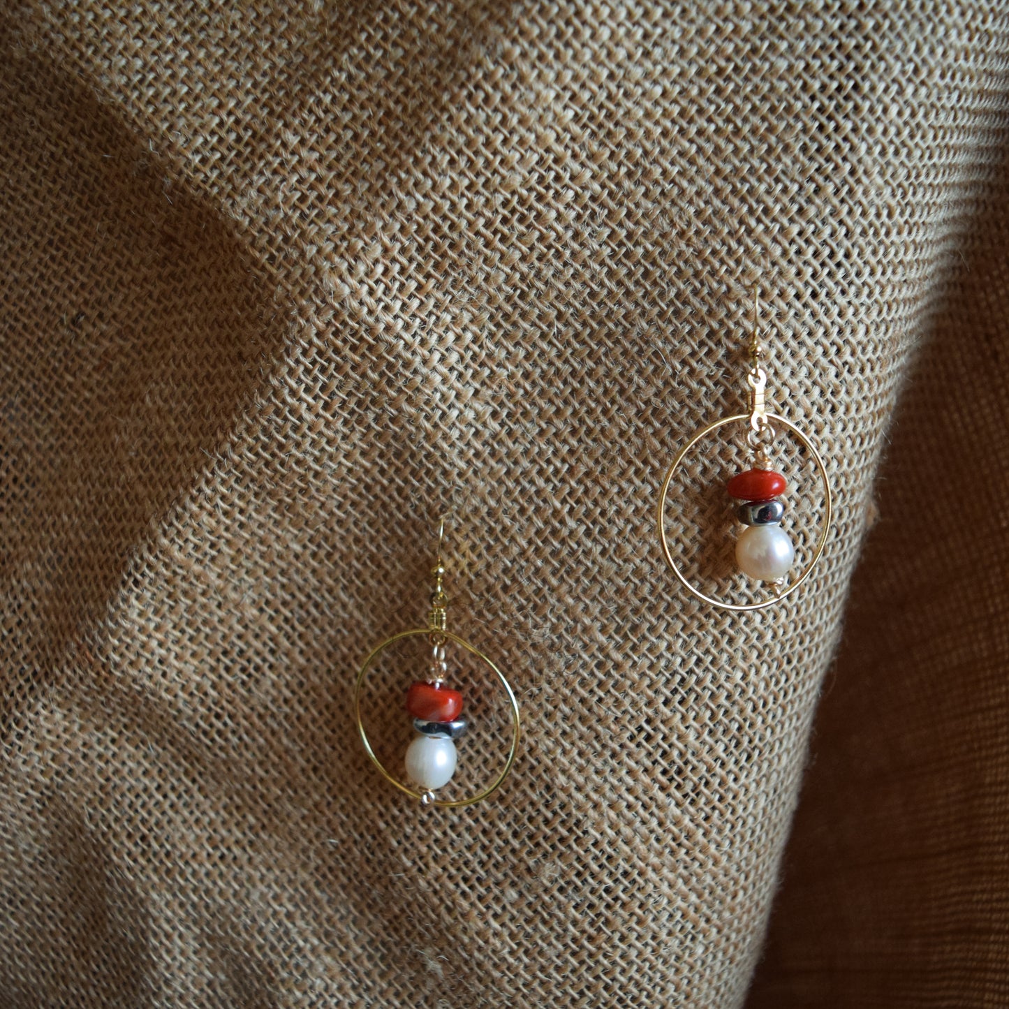 Handcrafted earrings with hematite, coral, and potatoe pearl beads for elegant, refined style by Ayiti Chérie. Haitian-inspired, lifestyle brand