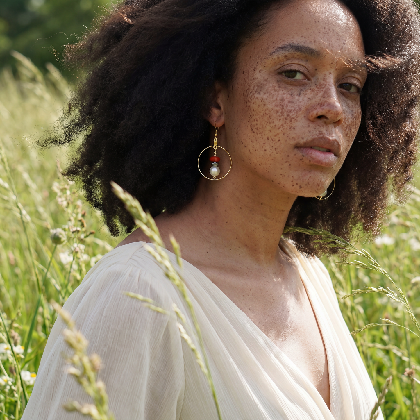 Handcrafted earrings with hematite, coral, and potatoe pearl beads for elegant, refined style by Ayiti Chérie. Haitian-inspired, lifestyle brand