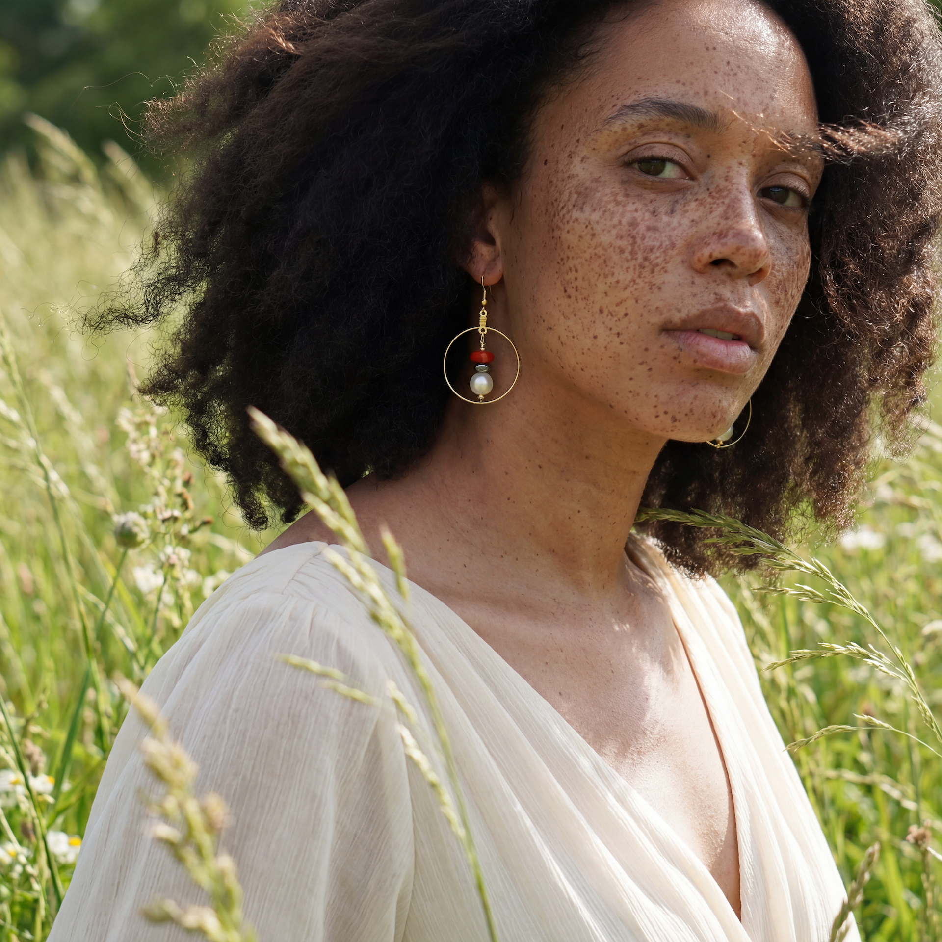 Handcrafted earrings with hematite, coral, and potatoe pearl beads for elegant, refined style by Ayiti Chérie. Haitian-inspired, lifestyle brand