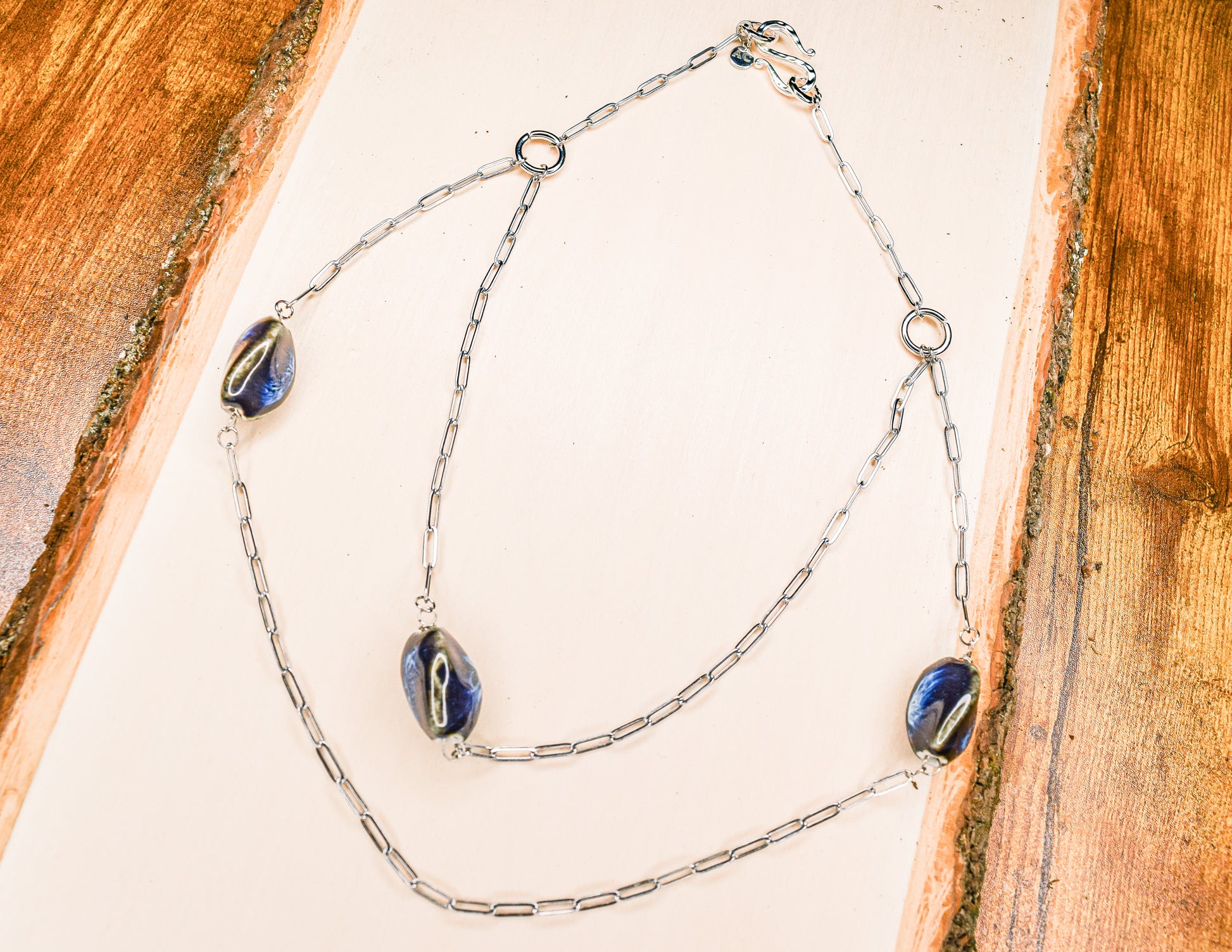 Handcrafted with silver paper-clip chain featuring twisted oval ceramic beads for elegant, refined style by Ayiti Chérie. Haitian-inspired, lifestyle brand