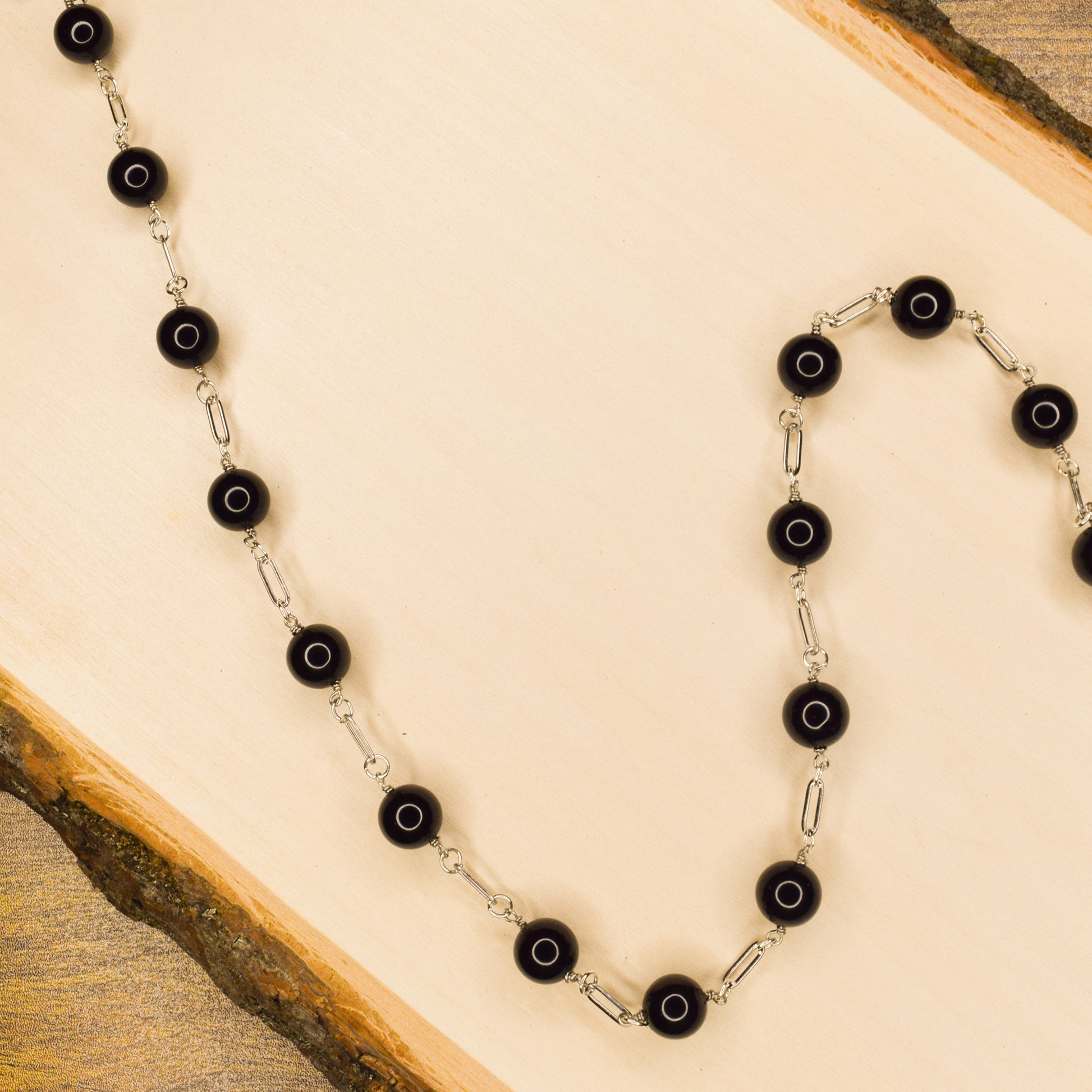 Handcrafted with paperclip links, featuring onyx beads for elegant, refined style by Ayiti Chérie. Haitian-inspired, lifestyle brand