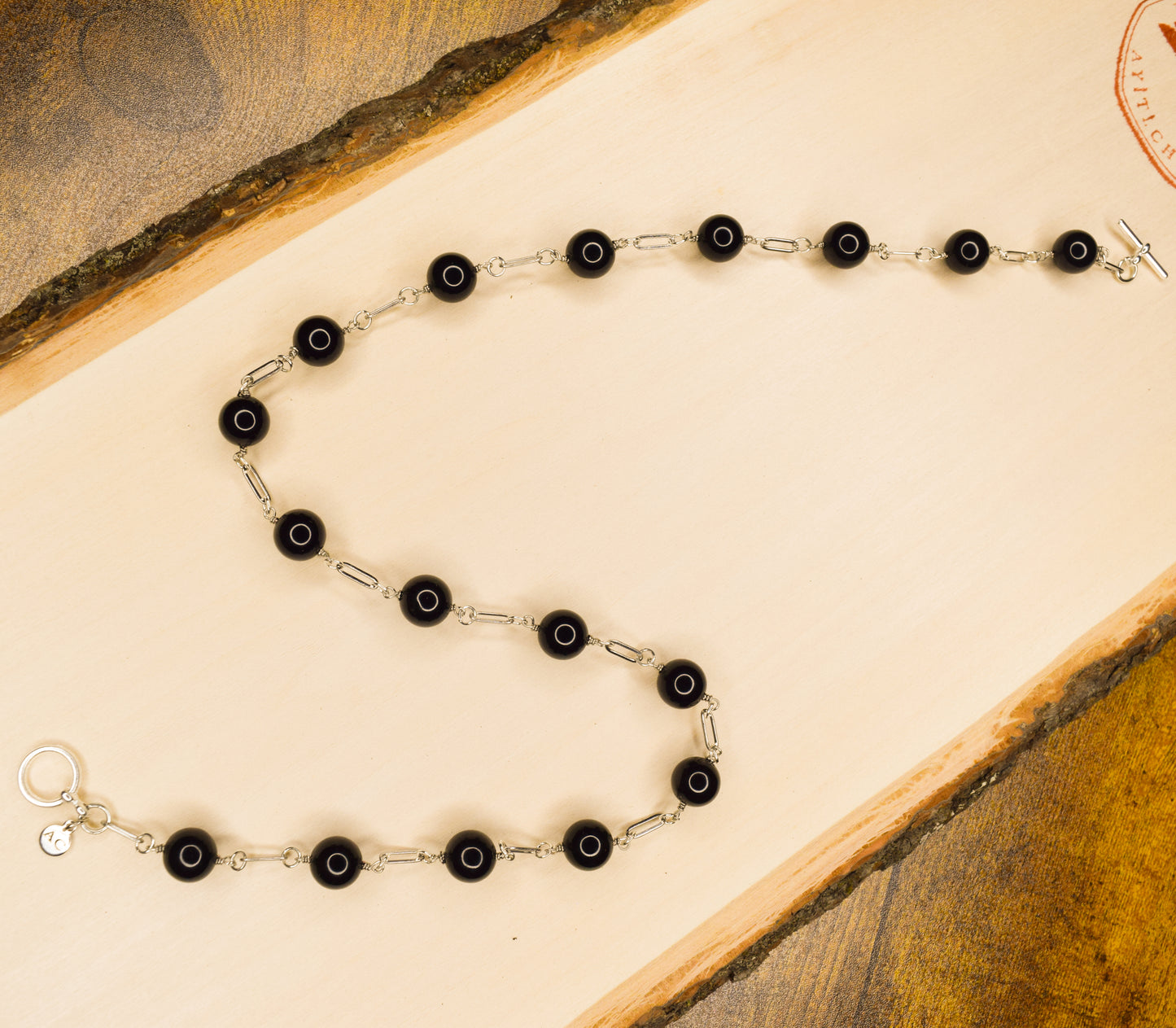 Handcrafted with paperclip links, featuring onyx beads for elegant, refined style by Ayiti Chérie. Haitian-inspired, lifestyle brand