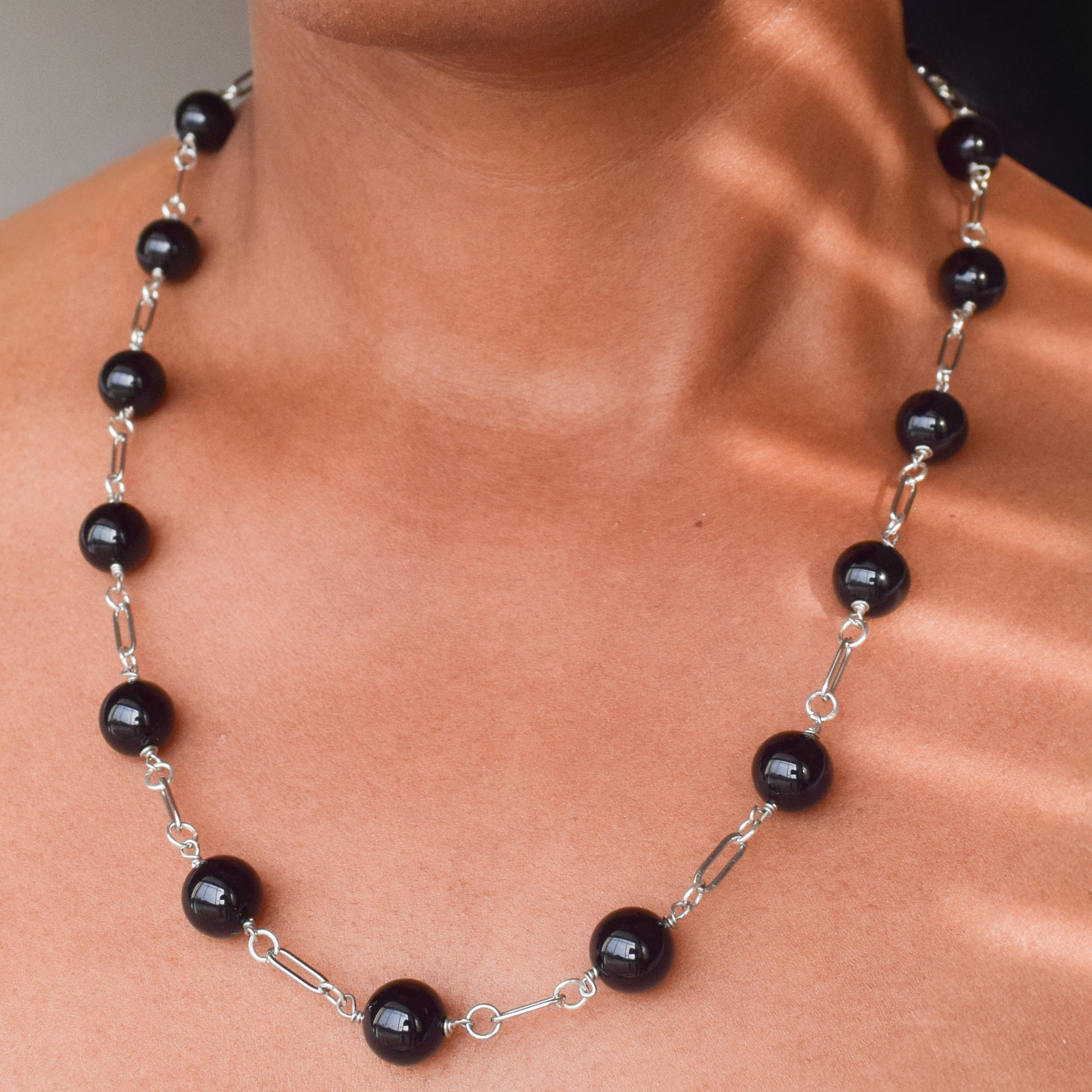 Handcrafted with paperclip links, featuring onyx beads for elegant, refined style by Ayiti Chérie. Haitian-inspired, lifestyle brand