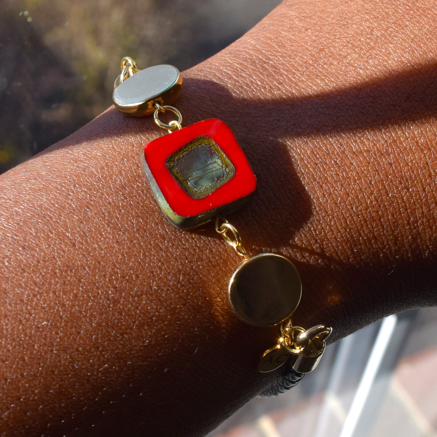 Handcrafted bracelet- Mosaic glass metal disc beads, and braided leather for refined, modern elegance. Haitian-inspired, lifestyle brand