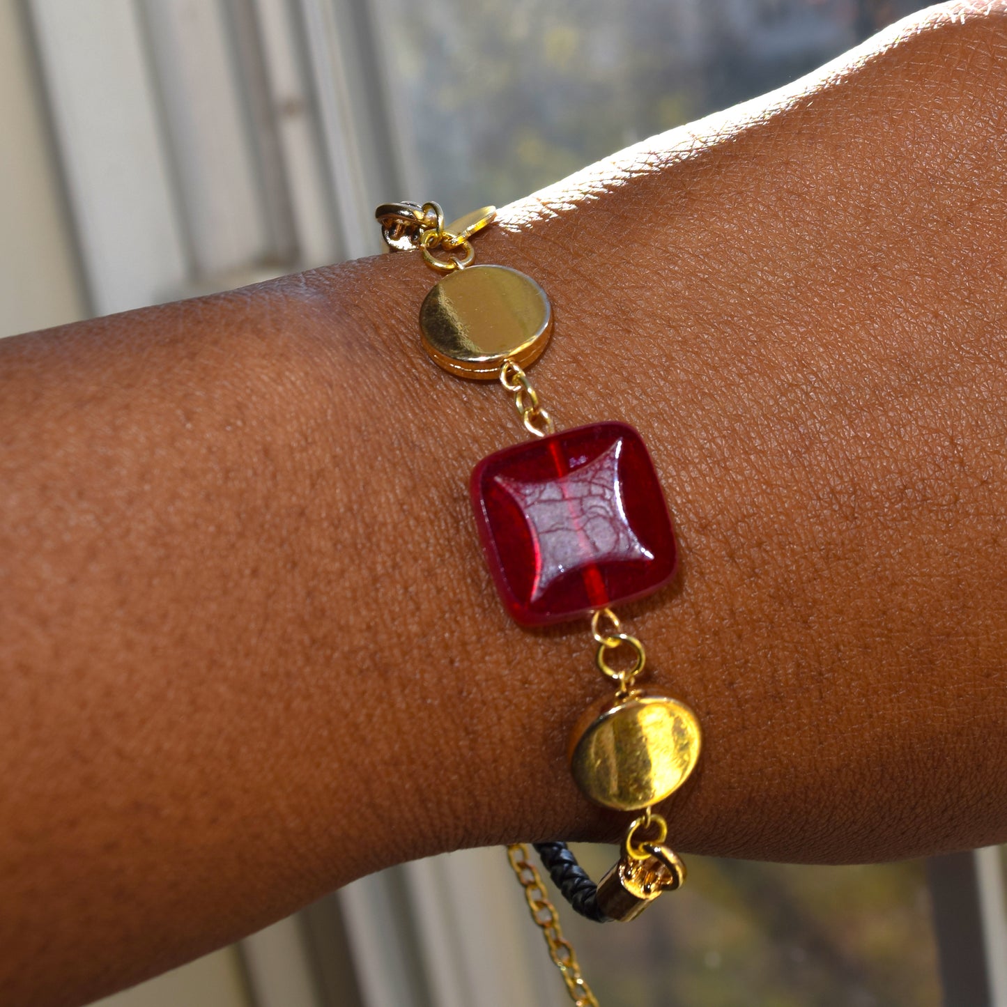 Handcrafted bracelet- Mosaic glass metal disc beads, and braided leather for refined, modern elegance. Haitian-inspired, lifestyle brand