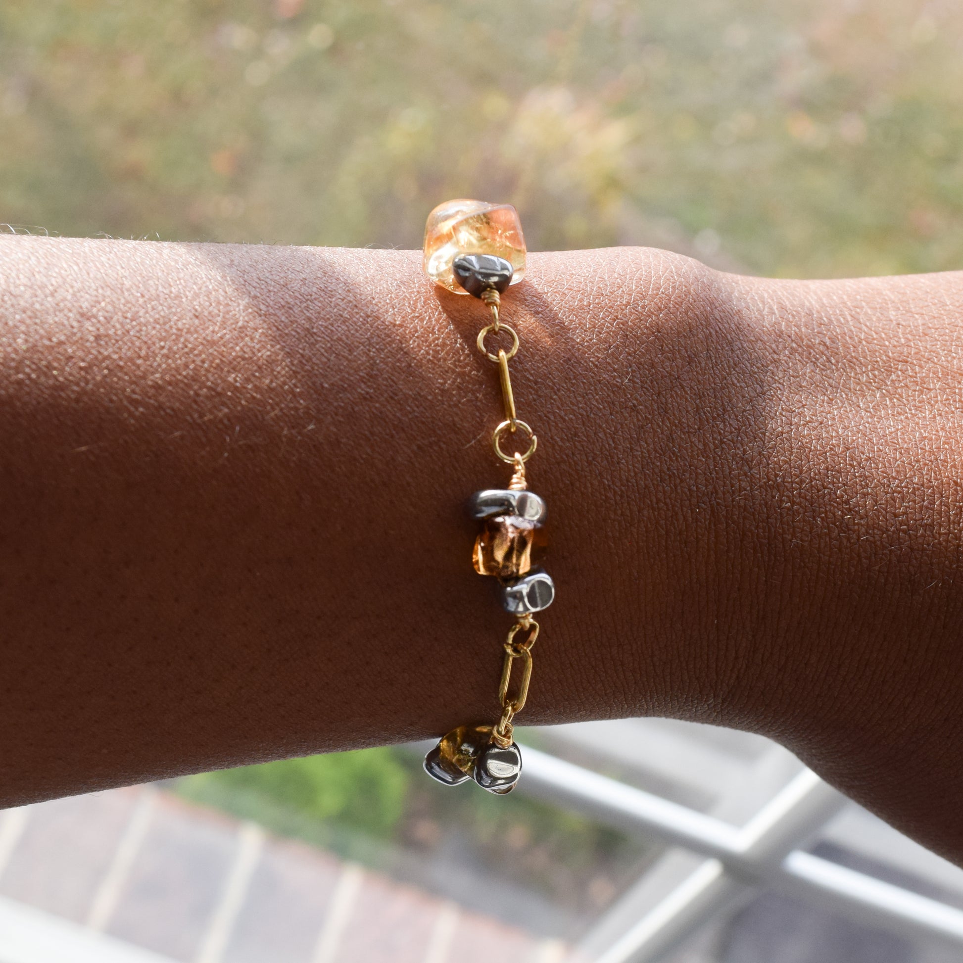 Handcrafted with 18K gold-plated paperclip chain, featuring citrine and hematite for elegant, refined style by Ayiti Chérie. Haitian-inspired, lifestyle brand