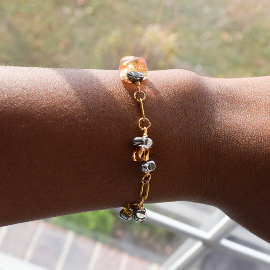 Handcrafted with 18K gold-plated paperclip chain, featuring citrine and hematite for elegant, refined style by Ayiti Chérie. Haitian-inspired, lifestyle brand