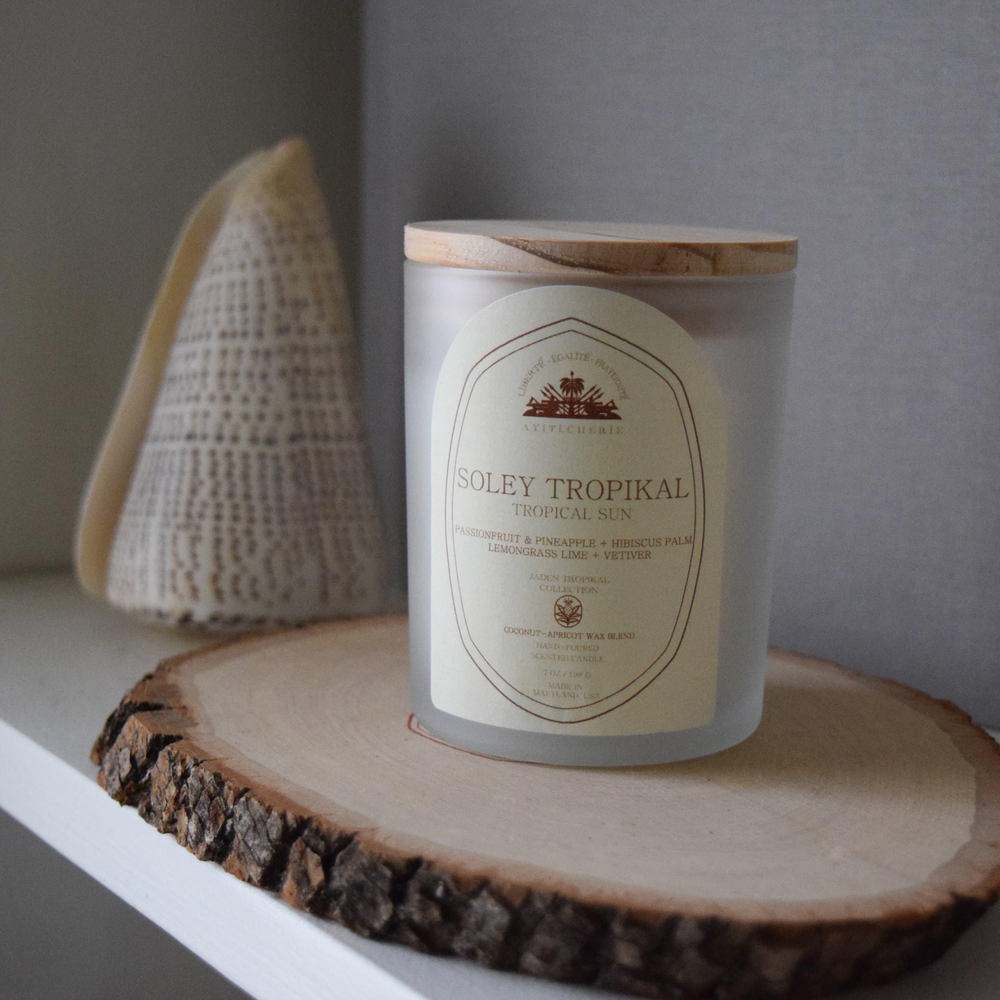 Haitian-inspired candle with passionfruit, pineapple, hibiscus palm, lemongrass lime, and vetiver by Ayiti Cherie 