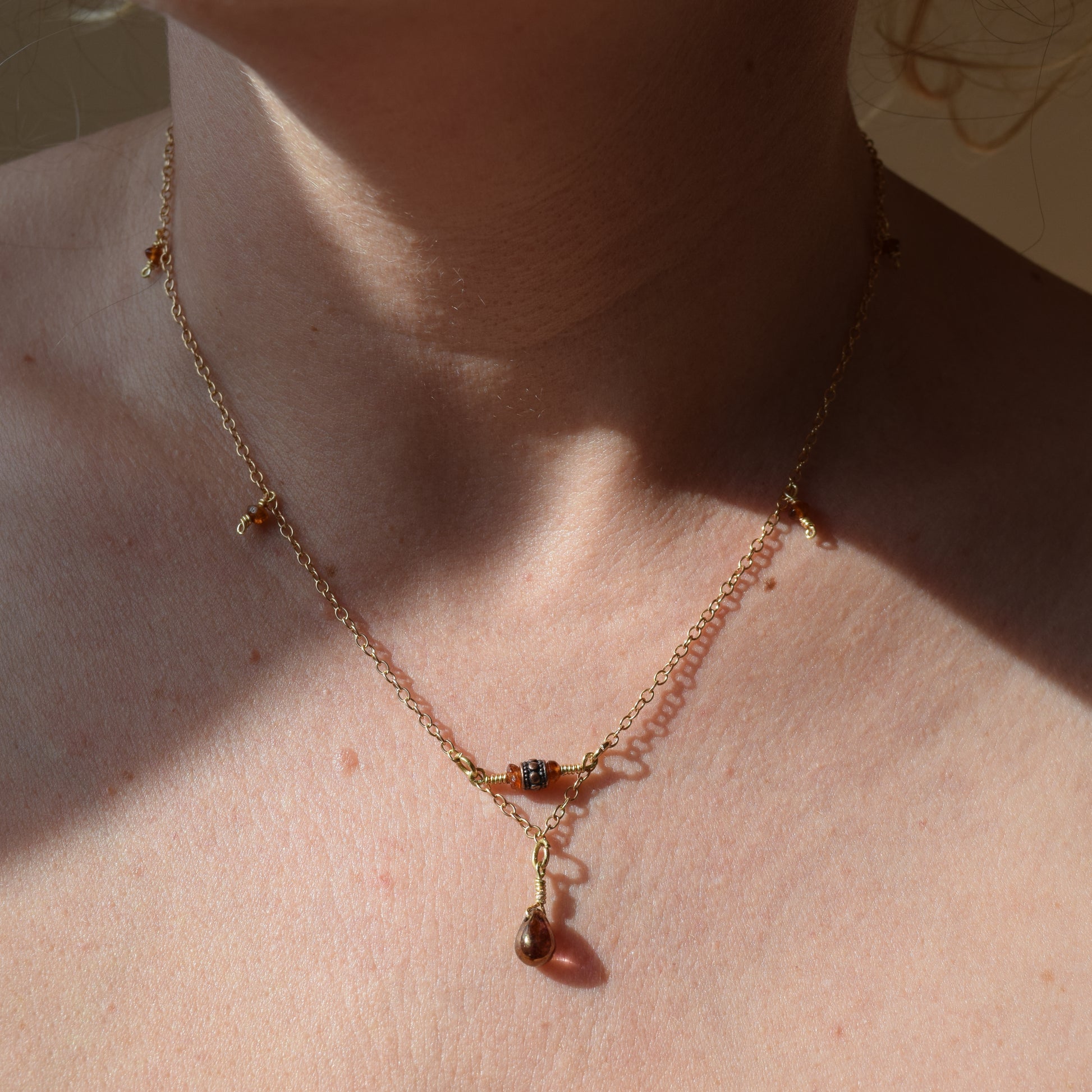 Handcrafted- Delicate curb chain, carnelian, carved drum and teardrop glass beads for elegant, refined style by Ayiti Chérie. Haitian-inspired, lifestyle brand