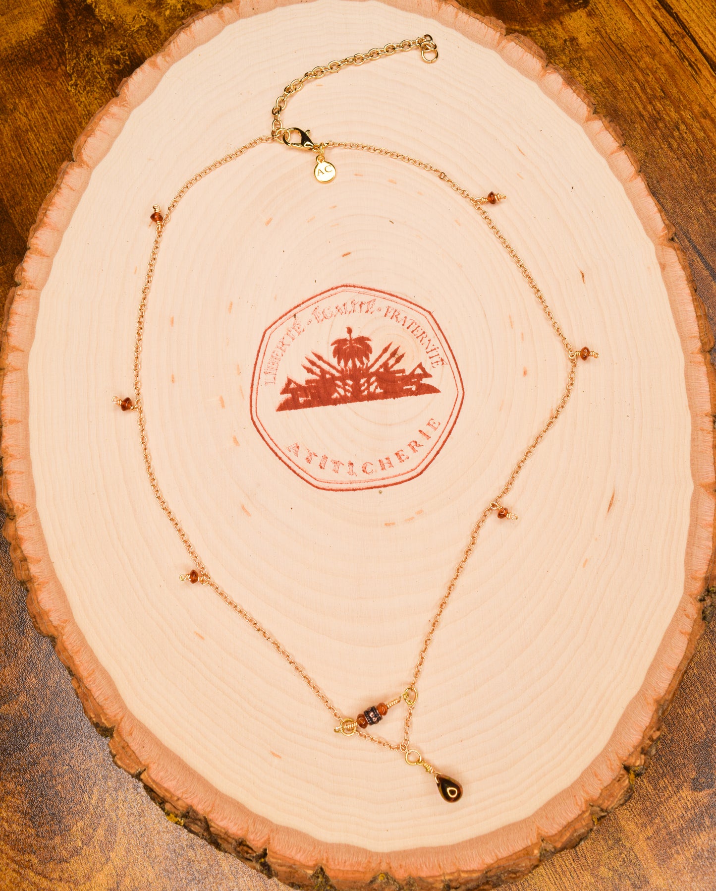 Handcrafted- Delicate curb chain, carnelian, carved drum and teardrop glass beads for elegant, refined style by Ayiti Chérie. Haitian-inspired, lifestyle brand