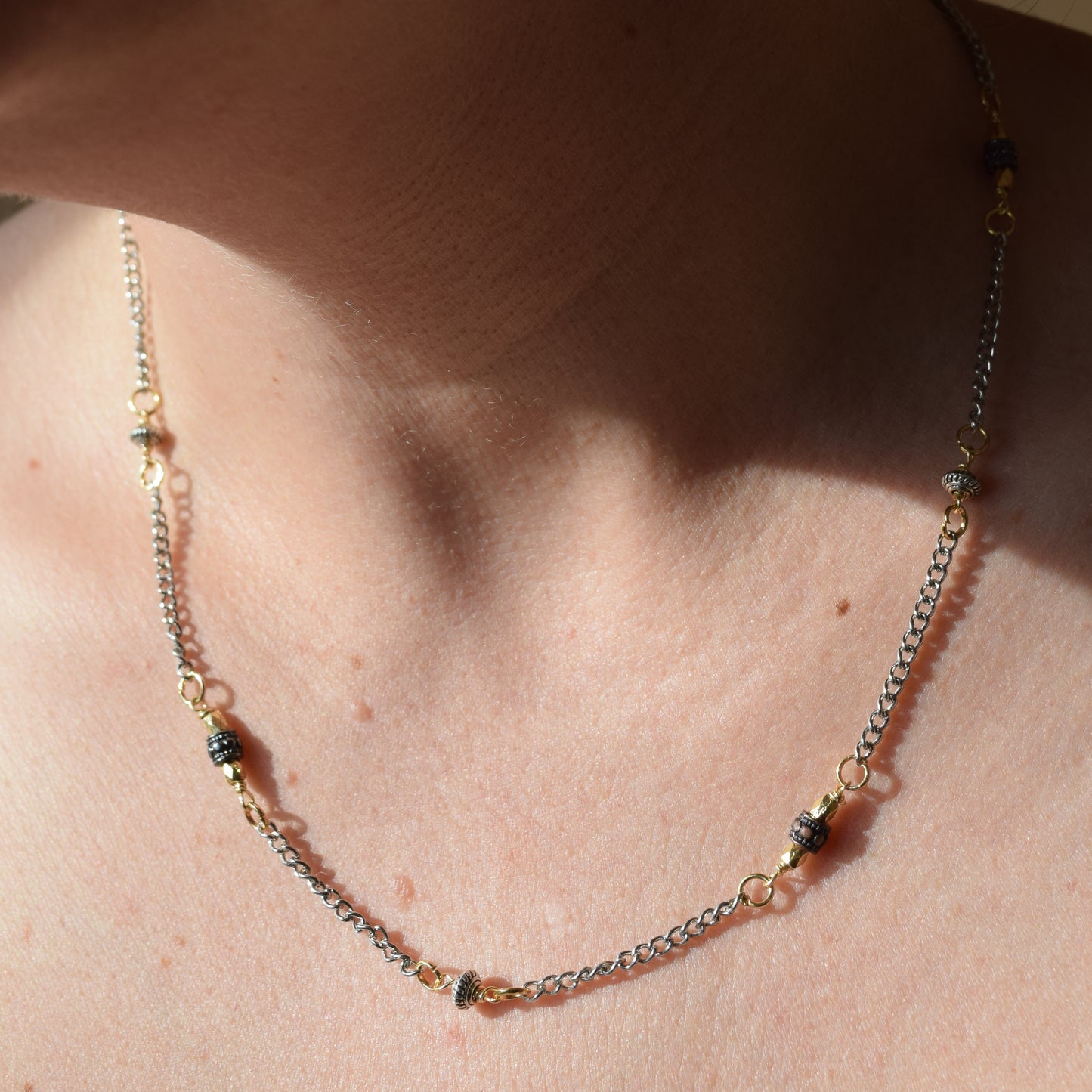 Handcrafted with delicate curb chain, featuring drum and bicone metal beads for elegant, refined style by Ayiti Chérie. Haitian-inspired, lifestyle brand