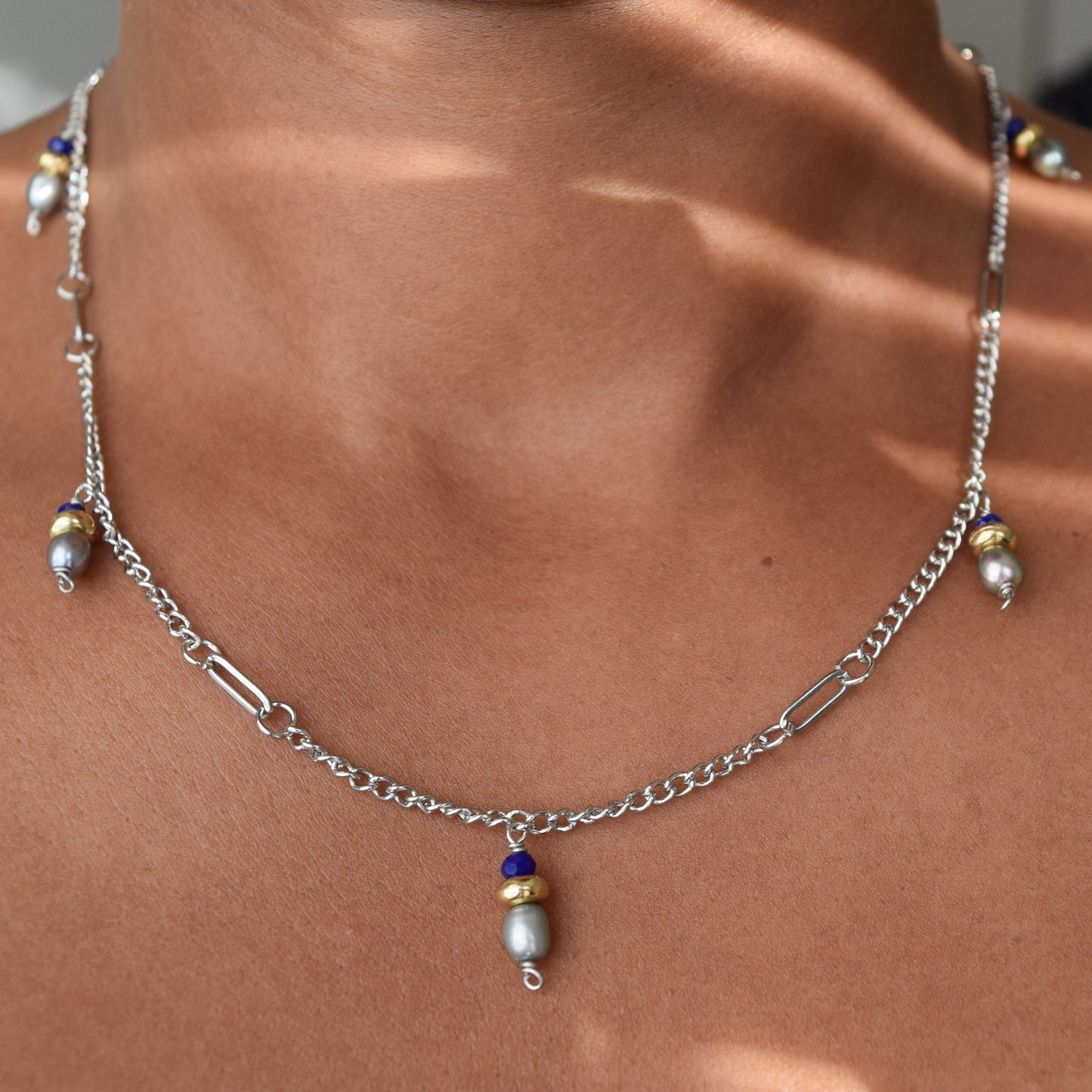 Handcrafted with silver curb & paper clip chain, featuring pearls & glass beads for elegant, refined style by Ayiti Chérie. Haitian-inspired, lifestyle brand
