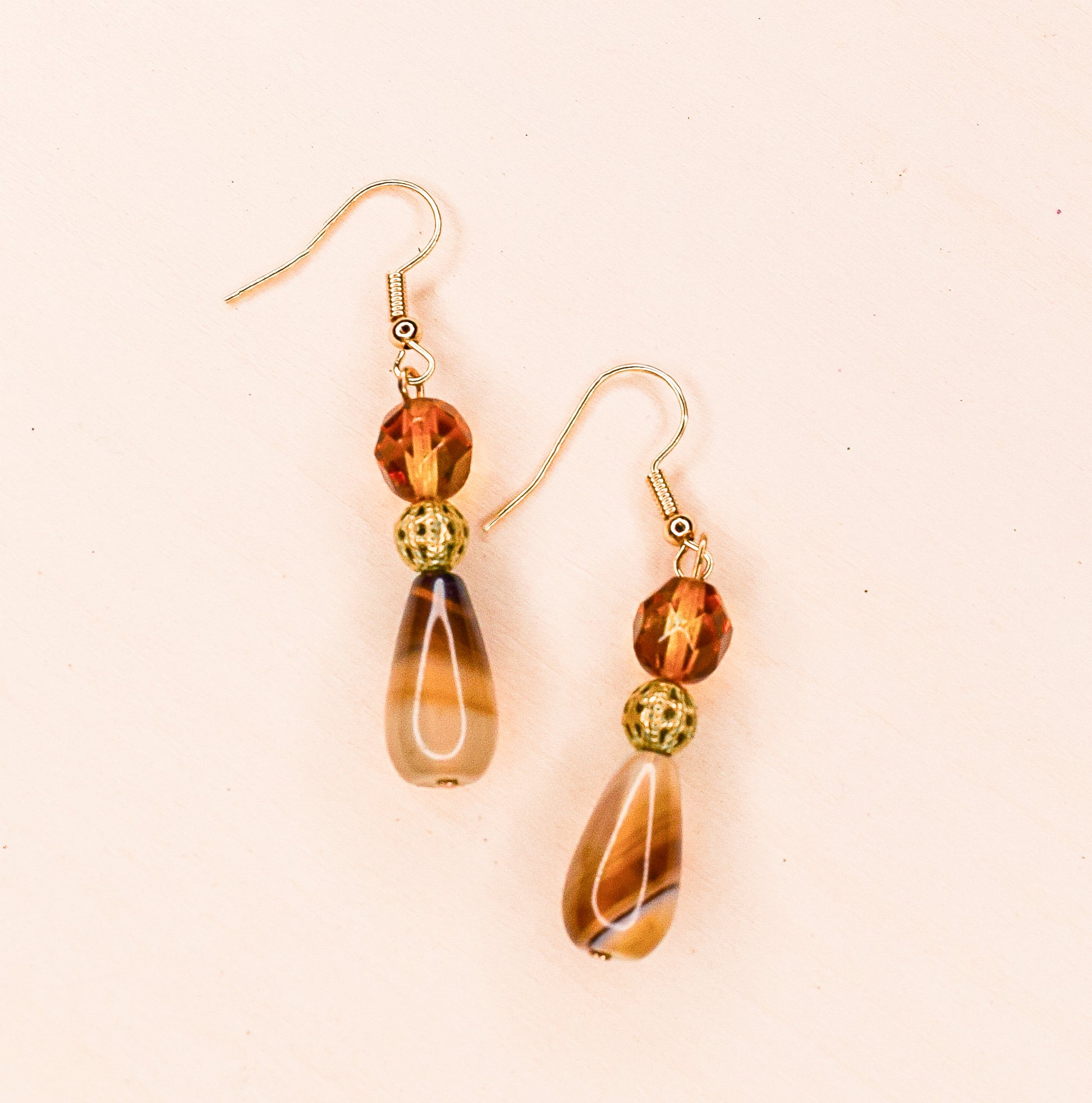Handcrafted earrings- Agate teardrops, faceted glass & gold cage bead details for refined, modern elegance. Haitian-inspired, lifestyle brand