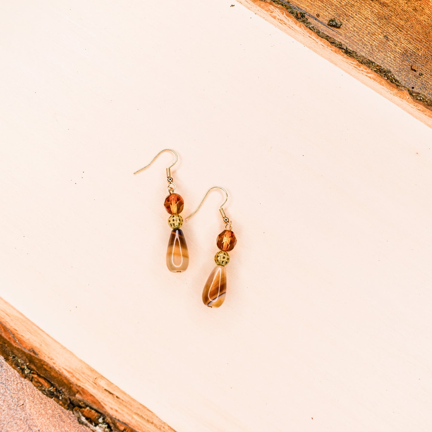 Handcrafted earrings- Agate teardrops, faceted glass & gold cage bead details for refined, modern elegance. Haitian-inspired, lifestyle brand