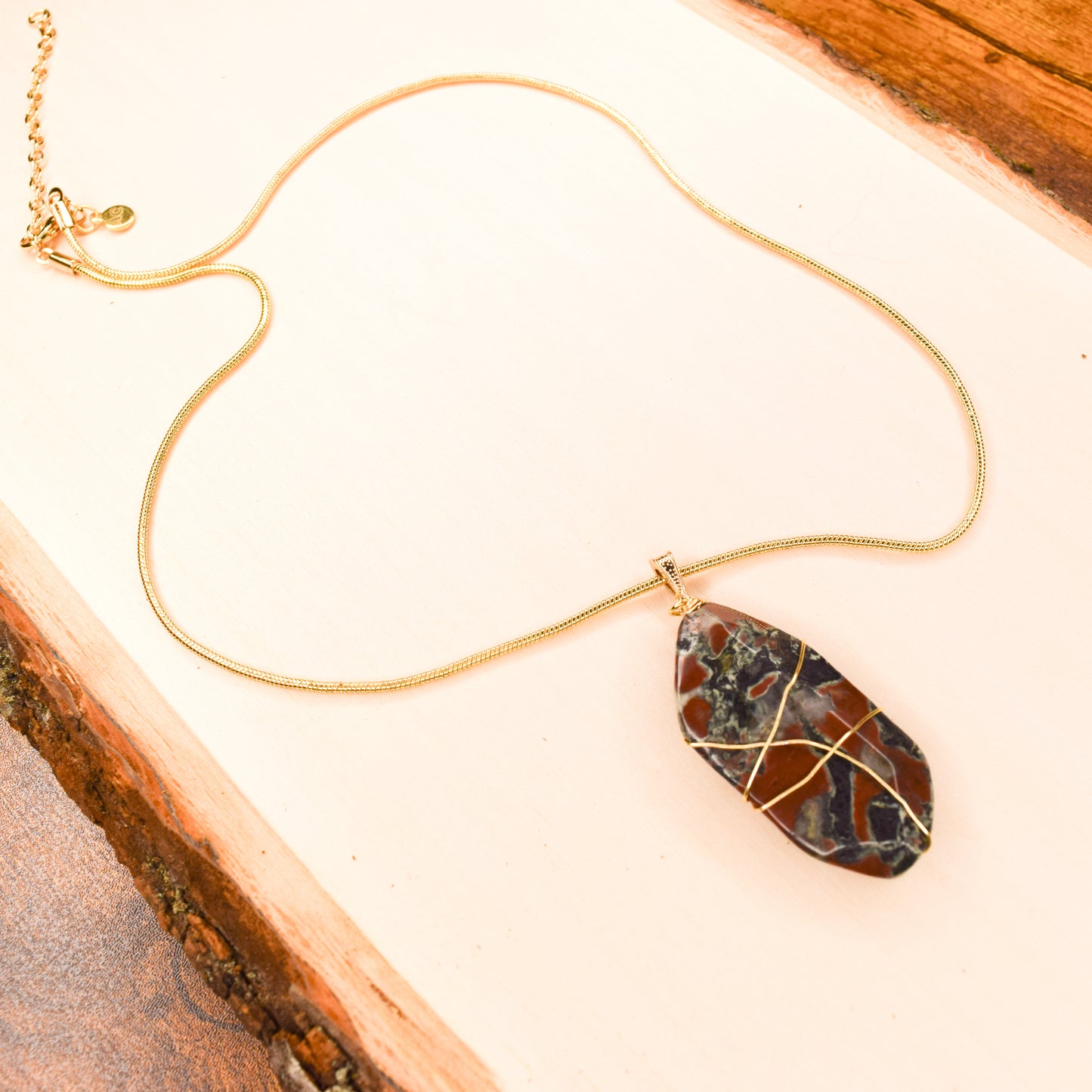 Handcrafted with a wire-wrapped snakeskin pendant for elegant, refined style by Ayiti Chérie. Haitian-inspired, lifestyle brand