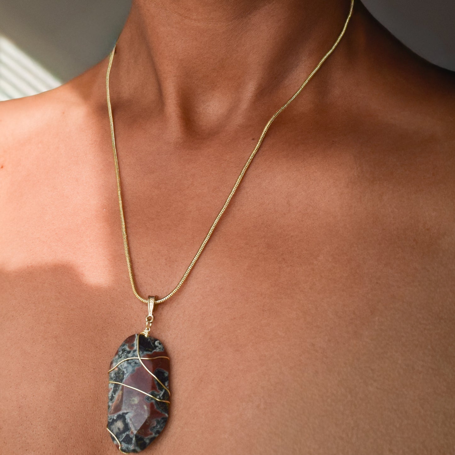 Handcrafted with a wire-wrapped snakeskin pendant for elegant, refined style by Ayiti Chérie. Haitian-inspired, lifestyle brand