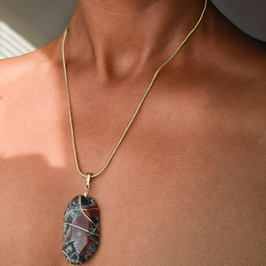 Handcrafted with a wire-wrapped snakeskin pendant for elegant, refined style by Ayiti Chérie. Haitian-inspired, lifestyle brand